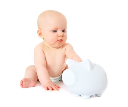 Newborn child playing with piggy bank. All isolated on white background.