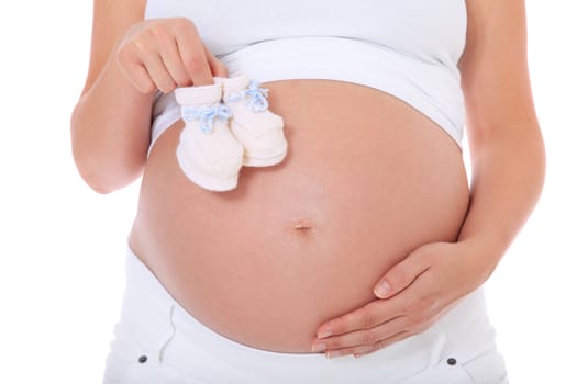 Pregnant woman holding baby shoes. All on white background.