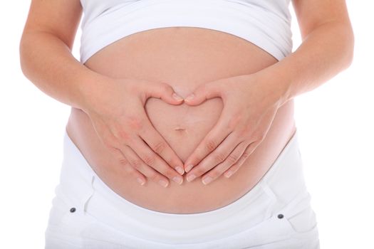 Pregnant woman forming heart out of her hands on her baby bump. All on white background.