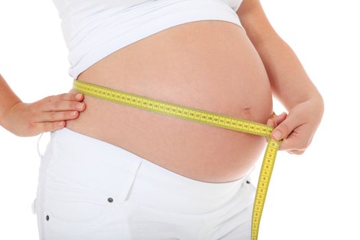 Pregnant woman measuring her belly. All on white background.