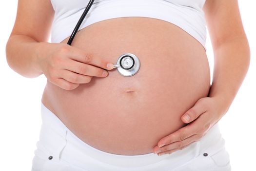 Pregnant woman using stethoscope to hear her babies heart tones. All on white background.