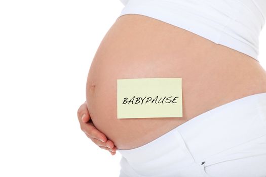 Pregnant woman with post-it note showing the german term "Babypause". All on white background.