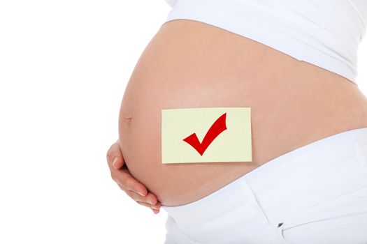 Pregnant woman with checkmark on baby bump. All on white background.