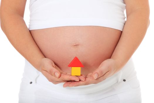 Pregnant woman holding small house. All on white background.