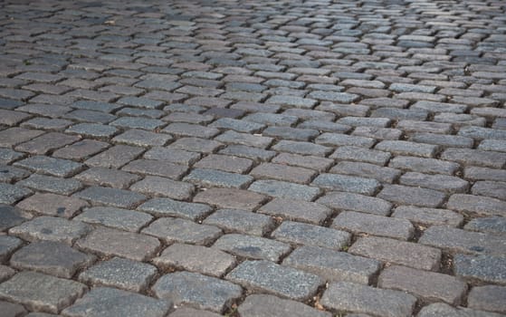 Grey cobbled pavement, background texture.