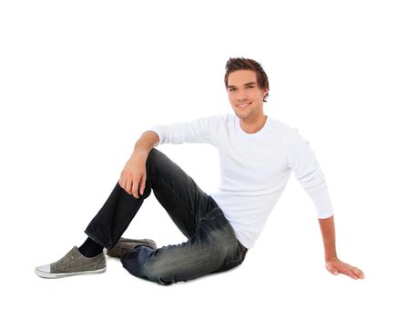 Attractive young man sitting. All on white background.