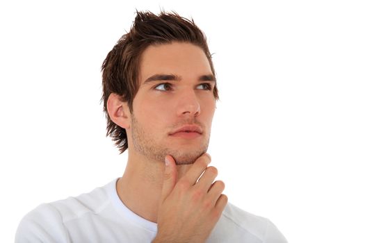 Attractive young man deliberates a decision. All on white background.