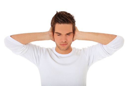 Attractive young man keeps his ears shut. All on white background.