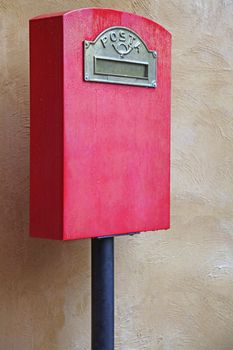 Red Italian Postal Box against Yellow Brick wall