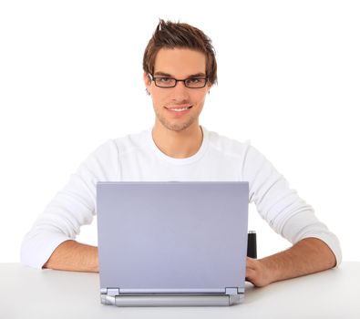 Smiling young guy using notebook computer. All on white background.