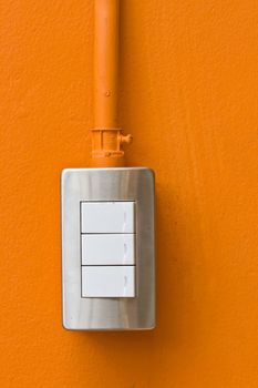 Light Switch on Orange Wall