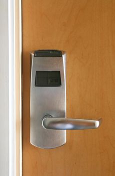 Keycard electronic lock on closed wooden door