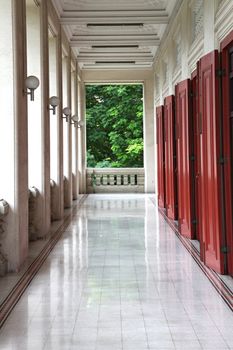 Corridor of Thai Style building to green tree