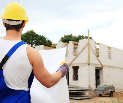 Manual worker on construction site during building inspection.