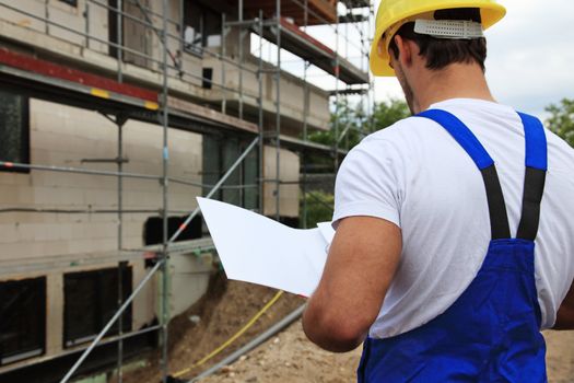 Manual worker on construction site during building inspection.