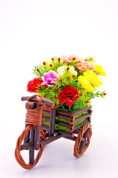 beautiful and colorful flower bouquet in wooden basket in car shape, vertical