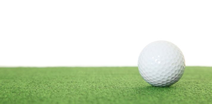 A single golf ball lying on the green. All isolated on white background.