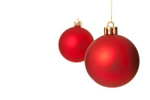 Two red christmas tree ball ornaments. Isolated on white background.