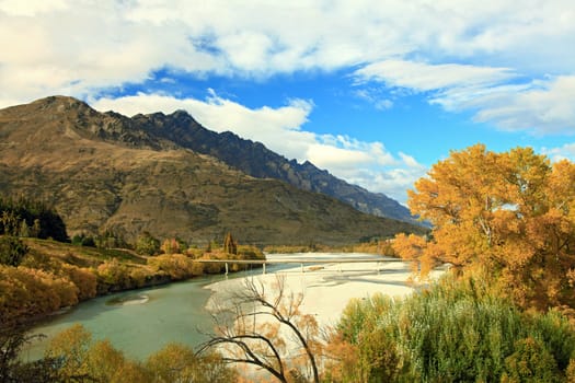 River and Lake From Historic Bridge with Mountain Landscape in Queenstowns New Zealand