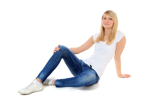 Attractive young woman sitting on the floor. All on white background.