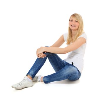 Attractive young woman sitting on the floor. All on white background.