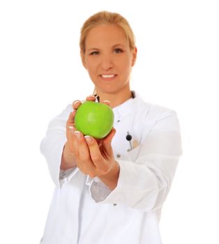 Smiling doctor holding green apple. All on white background.