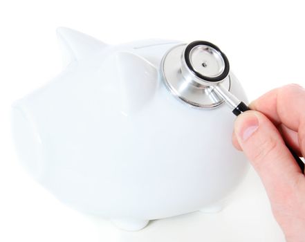 Human hand checks savings via stethoscope. All isolated on white background.