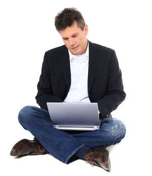 Attractive middle-aged man using notebook computer. All on white background.