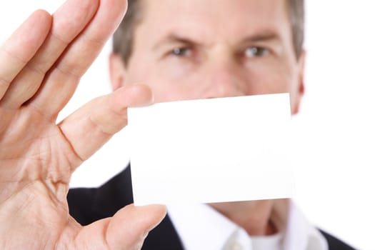 Attractive middle-aged man holding business card. All on white background. Selective focus on business card in foreground.