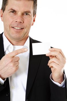 Attractive middle-aged man pointing at business card. All on white background.