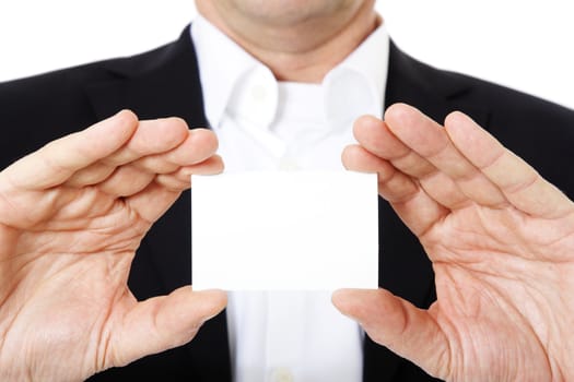 Attractive middle-aged man holding blank businesscard. All on white background.