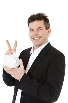 Attractive middle-aged man holding piggy bank. All on white background.