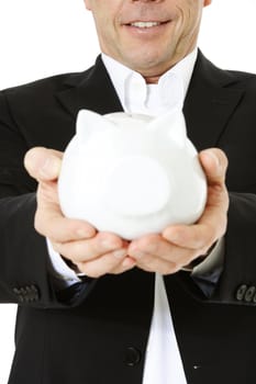 Middle-aged man holding piggy bank. All on white background. Selective focus on piggi bank in foreground.