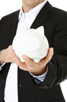 Middle-aged man holding piggy bank. All on white background. Selective focus on piggi bank in foreground.