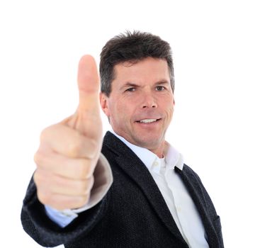 Attractive middle-aged man making thumbs up sign. All on white background.  Selective focus on thumb in foreground.
