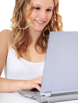 Attractive teenage girl using notebook computer. All on white background.