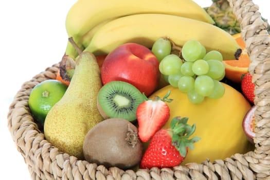 Basket full of various ripe fruits.