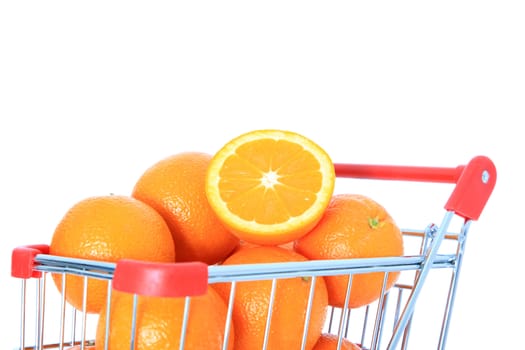 Ripe oranges in shopping cart. Isolated on white background.