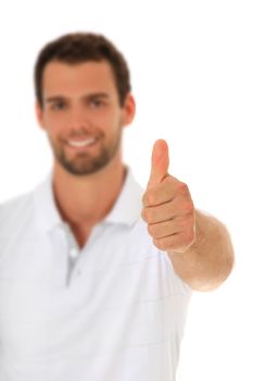 Young guy showing thumbs up. Selective focus on hand in foreground. All on white background.