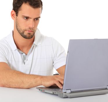 Young man working with laptop. All on white background.