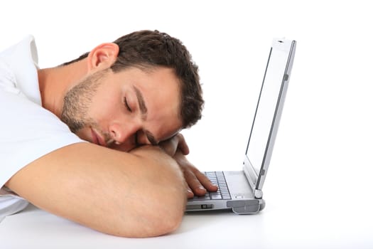 Young man taking a nap on his laptop. All on white background.