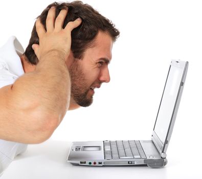 Frustrated man sitting in front of his laptop. All on white background.