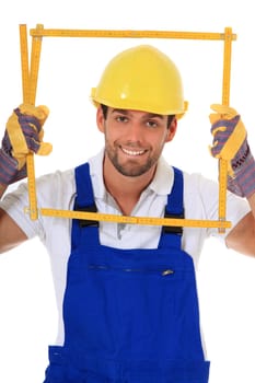 Clumsy construction worker looking through folding rule. All on white background.