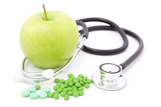 stethoscope with pills and apple, isolated on white background 