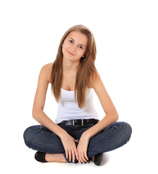 Full length shot of an attractive girl sitting on the floor. All on white background.