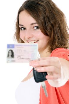 Young woman presenting her driver´s licence. All on white background.
