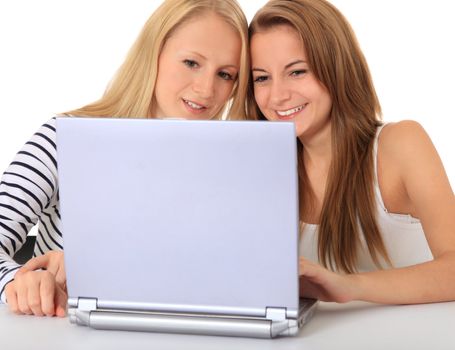 Two students working together on notebook computer. All on white background.