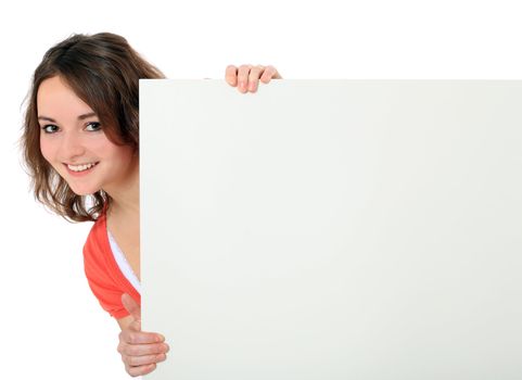 Attractive young woman standing behind white board. All on white background.