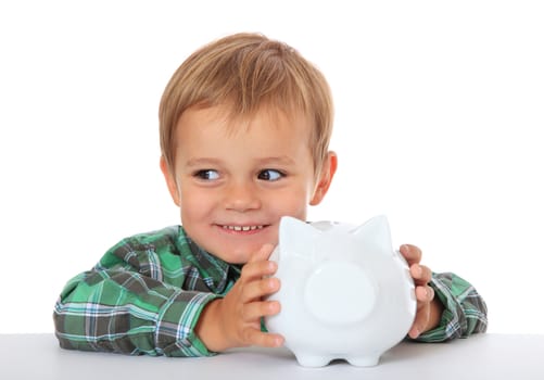 Cute caucasian boy holding piggy bank. All on white background.