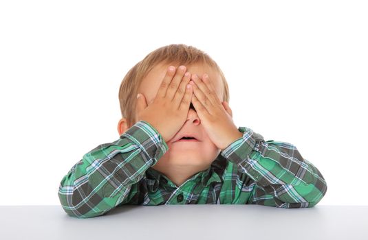 Cute caucasian boy hides himself. All on white background.